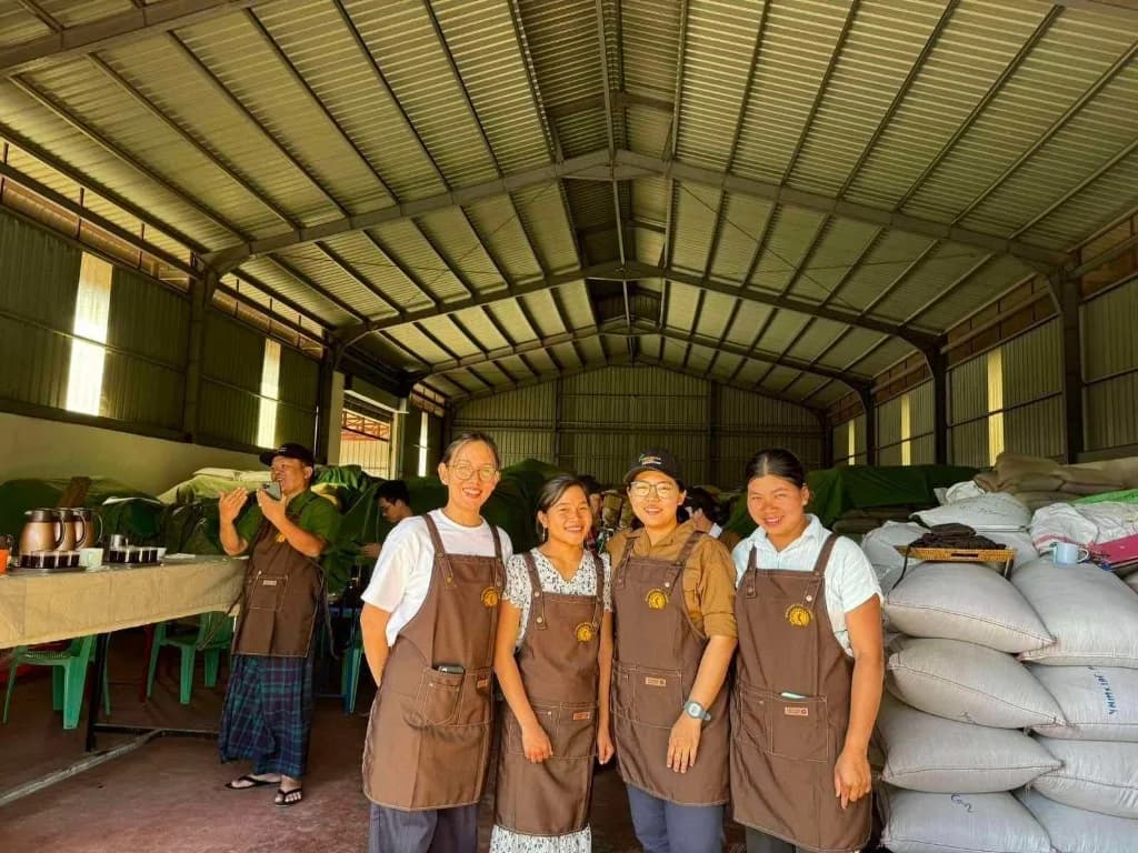 Lay Ywa cooperative team standing inside warehouse